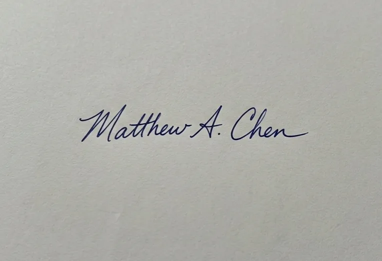 Original handwritten signature on paper with background